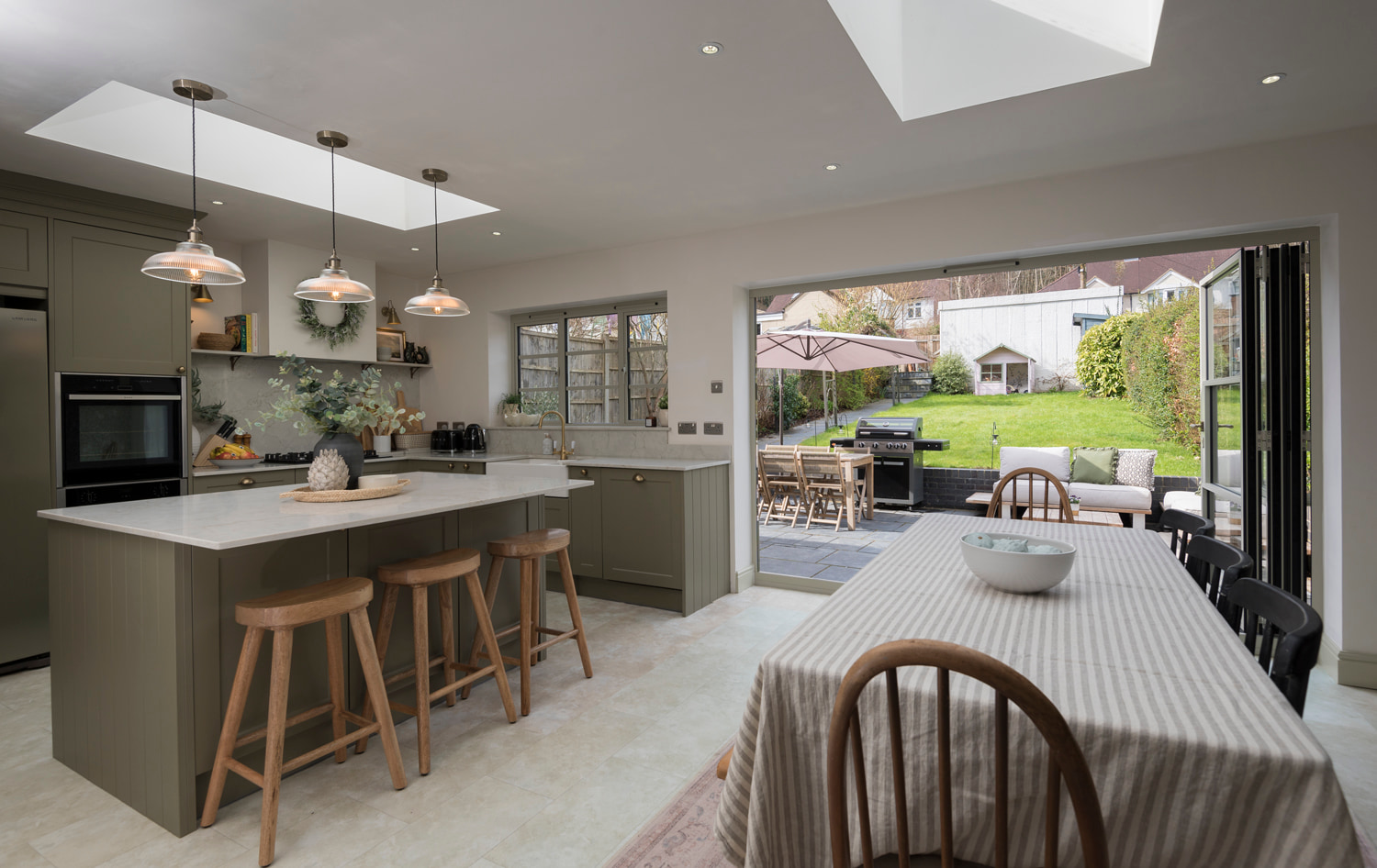 Opened Origin aluminium bifold doors.